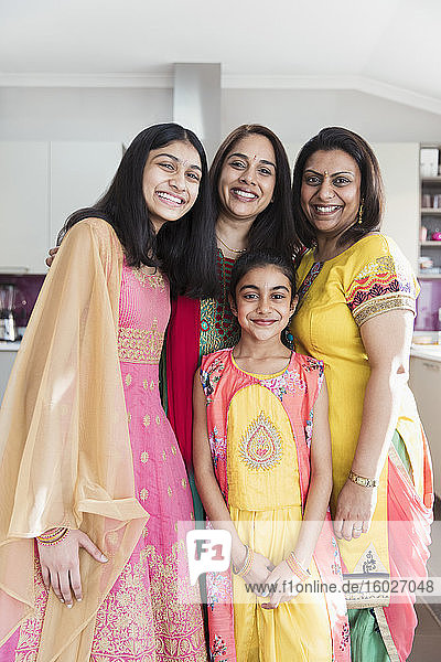 Portrait happy Indian mothers and daughters in saris