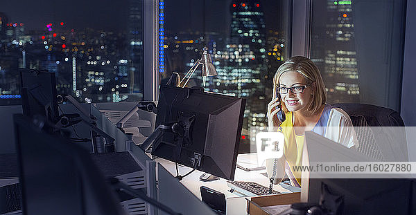 Businesswoman working late at computer in office
