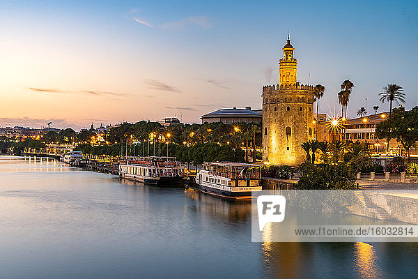 Sunset at Torre del Oro (Tower of Gold)  a watchtower on the bank of the Guadalquivir River in Seville  Andalusia  Spain  Europe