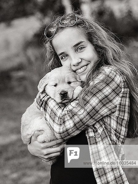 Porträt Teenagerin mit Golden Retriever-Welpe