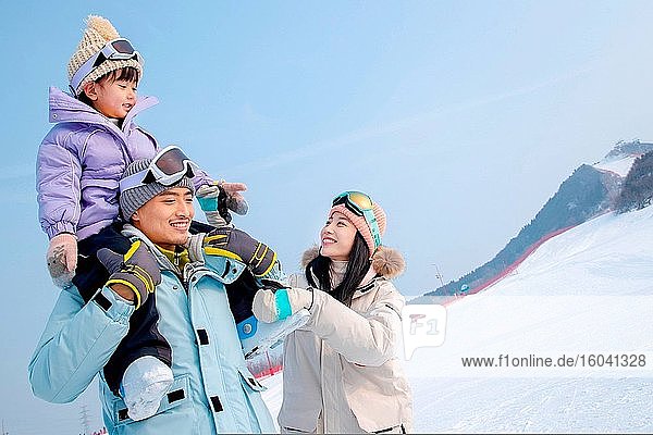 Ski field play happy family of three