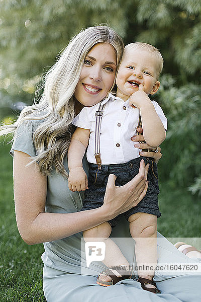 Outdoor portrait of smiling mother with baby son