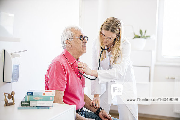 Female doctor examining senior patient in medical clinic