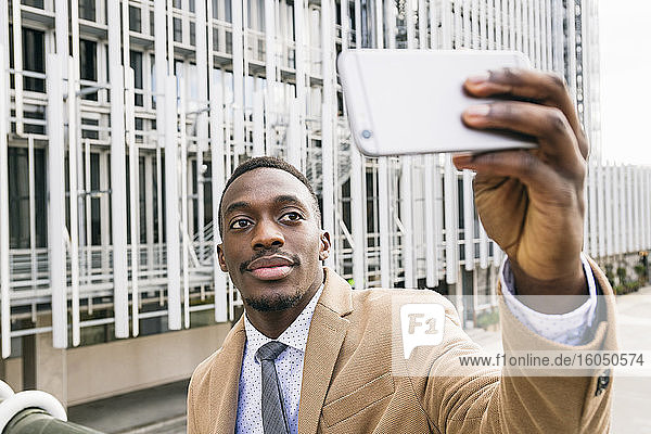Young businessman taking a selfie in the city