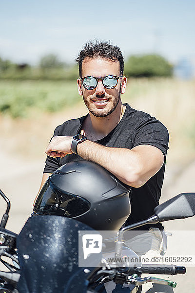 Biker with sunglasses sitting on motorbike