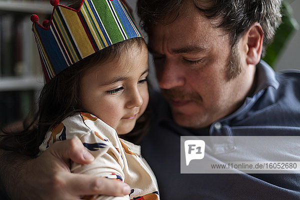 Portrait of little girl celebrating birthday with her father