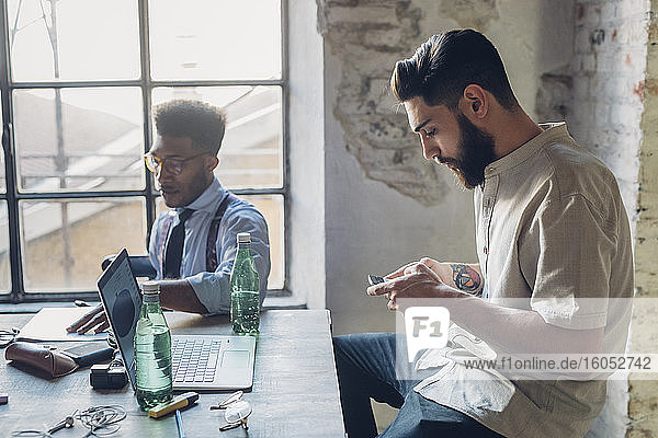 Creative business men working at table in loft office