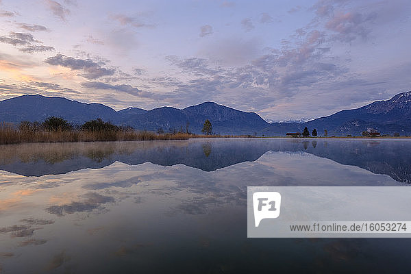 Germany  Bavaria  Schlehdorf  Mountains reflecting in Eichsee at dawn