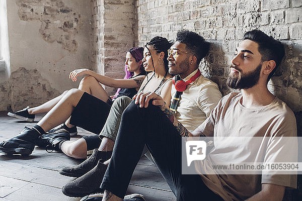 Group of friends sitting on the floor in a loft