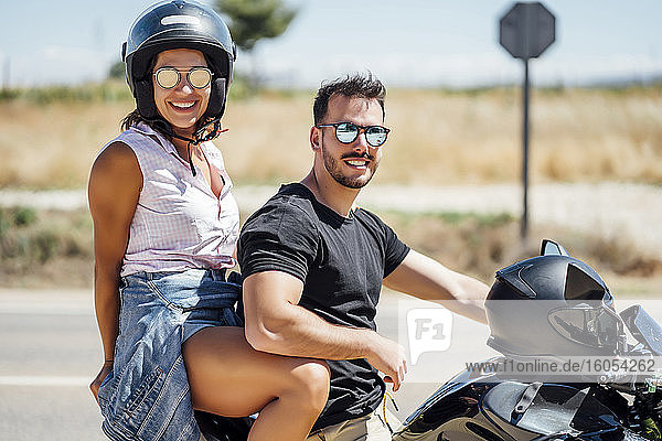Couple sitting on motorbike