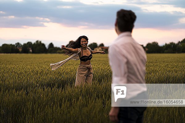 Dancing couple on field in the evening