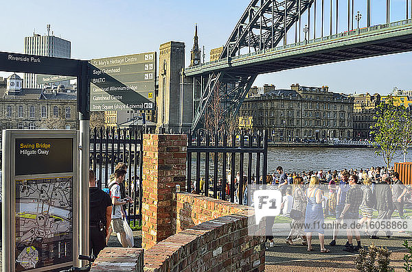 Menschen beim geselligen Beisammensein am Hillgate Quay mit Blick auf Swing Bridge und River Tyne; Newcastle Upon Tyne  Northumberland  England