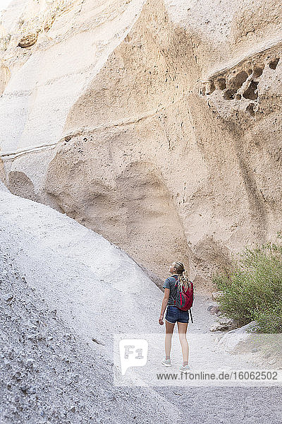 12 year old girl hiking in beautiful slot canyon Kasha Katuwe Tent Rocks NM.
