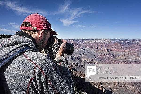 Tourist photographed in Grand Canyon  canyon landscape  eroded rock landscape  South Rim  Grand Canyon  Grand Canyon National Park  Arizona  USA  North America