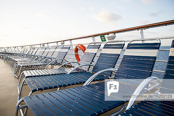 Liegestühle an Deck eines Kreuzfahrtschiffs