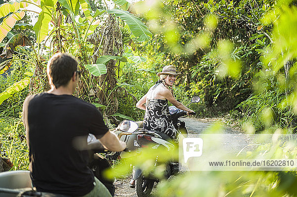 Paar fährt auf Motorrädern durch den Wald  Nusa Lembongan  Indonesien