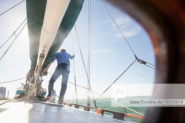 Man standing on deck of yacht