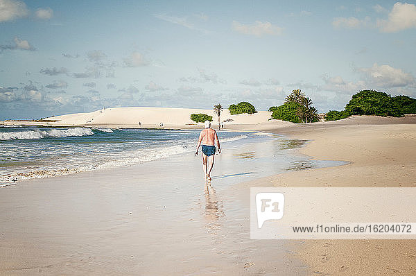 Man walking on tropical beach