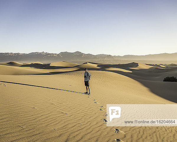 Man with binoculars  Mesquite Flat Sand Dunes  Death Valley National Park  Furnace Creek  California  USA