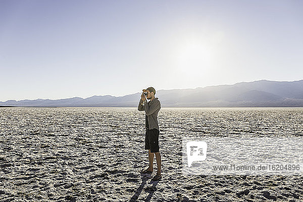 Man taking photograph  Badwater Basin  Death Valley National Park  Furnace Creek  California  USA