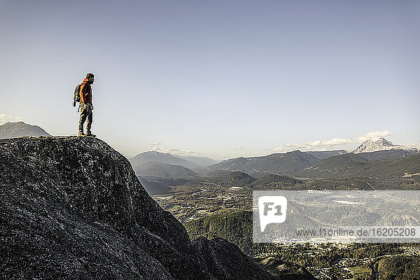 Man standing on mountain  looking at view  Stawamus Chief  overlooking Howe Sound Bay  Squamish  British Columbia  Canada