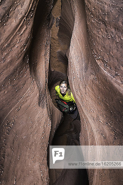 Woman exploring slot canyon Grand Staircase-Escalante National Monument  Utah  USA