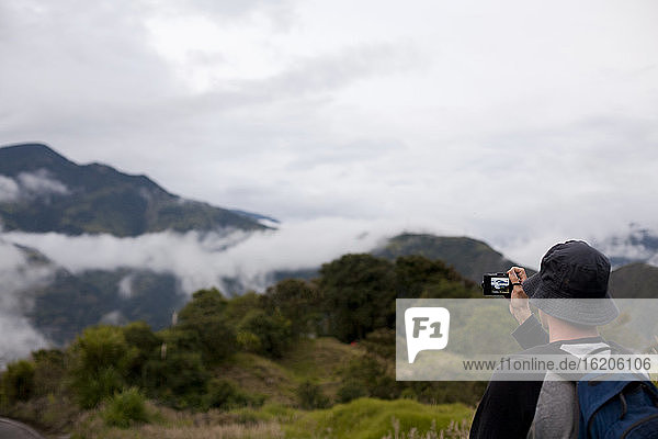 Tourist photographing distant view of the rainforest near Puyo  Ecuador