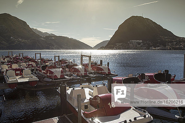 Pedalos moored on Lake Lugano, Tessin, Switzerland