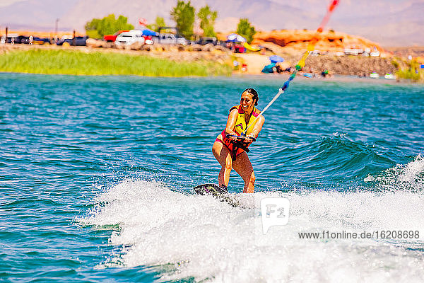 Woman wake boarding at the Sand Hollow Reservoir  Utah  United States of America  North America