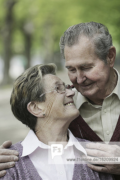 Germany  Cologne  Senior couple looking at each other in park  smiling