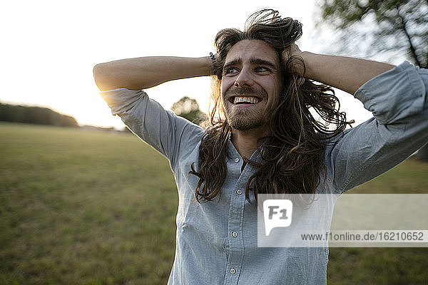 Happy young man on a meadow in the countryside