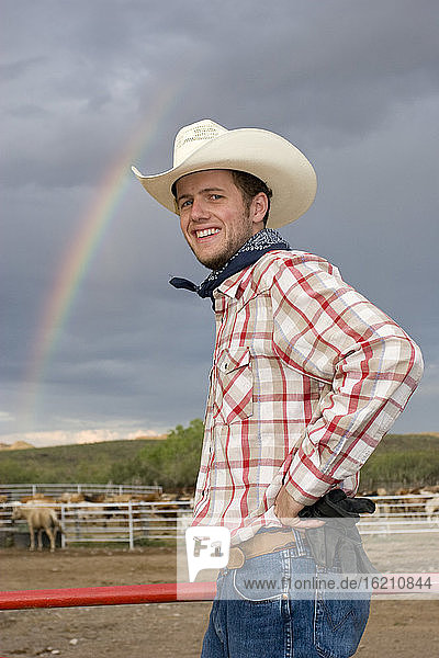USA  Texas  Dallas  Cowboy standing by pasture  smiling  portrait