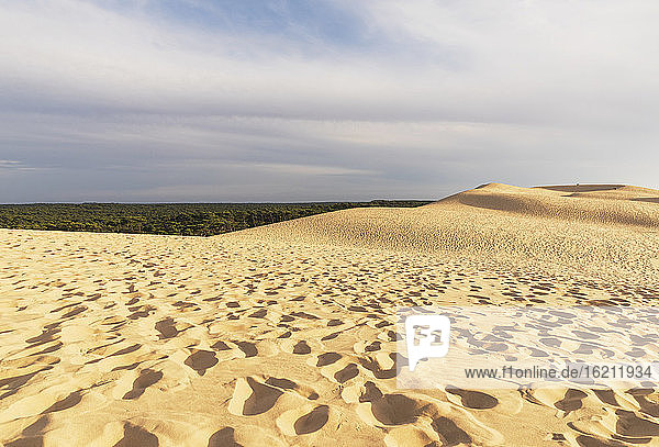 Dune of Pilat against cloudy sky during sunny day  Dune of Pilat  Nouvelle-Aquitaine  France