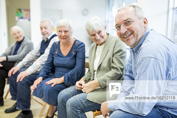 Senior citizens participating in group event in retirement home
