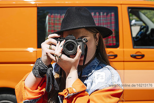 Young woman taking pictures with camera