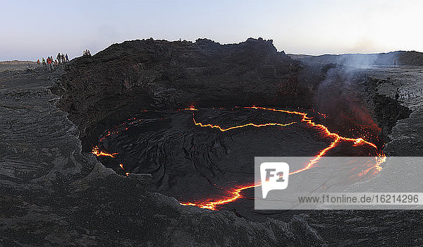Ethiopia  View of lava at Erta Ale while people in background