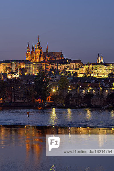 Czech Republic  Prague  Charles Bridge stretching over Vltava river at dusk with Prague Castle looming in background