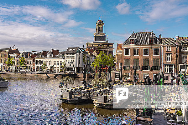 Netherlands  South Holland  Leiden  Restaurant on Nieuwe Rjin river canal with Hartebrugkerk in background