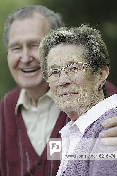 Germany  Cologne  Portrait of senior couple in park  smiling