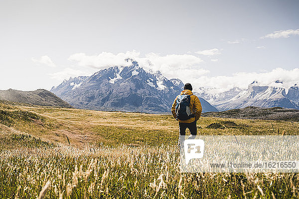 Man with backpack exploring Torres Del Paine National Park in Patagonia  South America