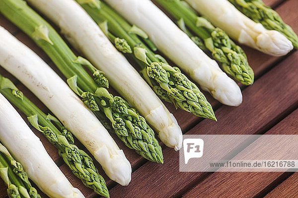 Germany  Saxony  Green asparagus on wooden table  close up