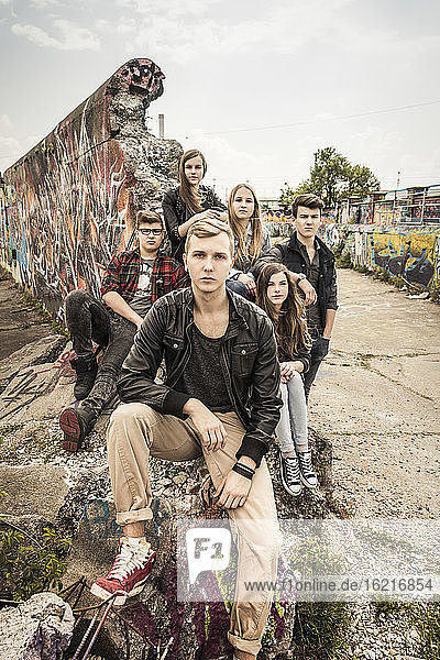 Portrait of group of friends hanging out in an old run down industrial area