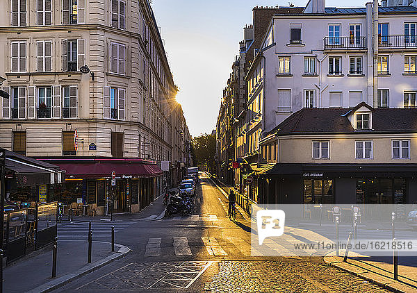 Road by buildings against clear sky during sunset  Paris  France