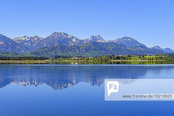Scenic view of Tannheim Mountains reflecting in Hopfensee lake