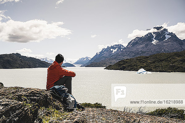 Man looking at river while sitting at Torres Del Paine National Park  Patagonia  Chile  South America