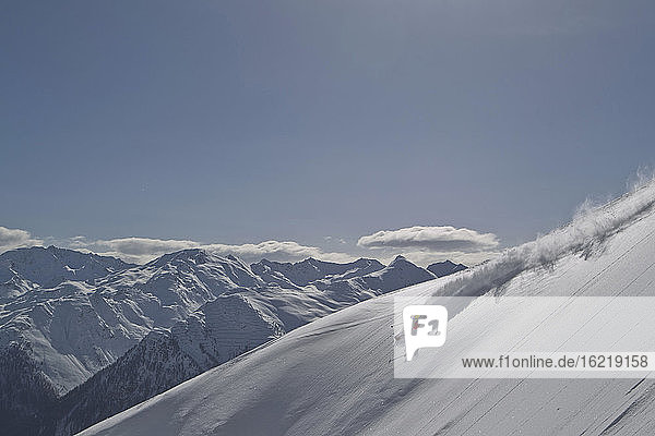 Österreich  Mann beim Skifahren auf schneebedeckten Bergen