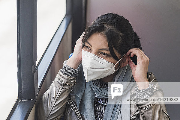 Woman wearing mask in bus during coronavirus outbreak