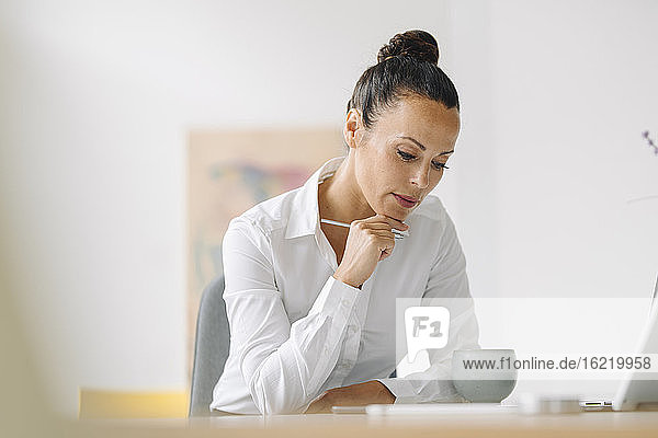 Geschäftsfrau arbeitet am Schreibtisch im Heimbüro