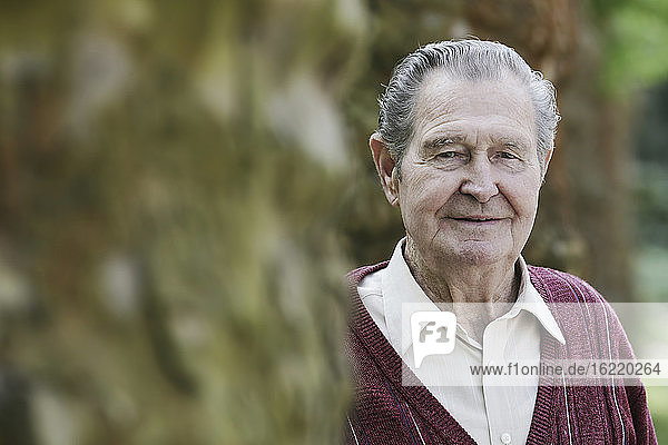 Germany  Cologne  Portrait of senior man in park  close up