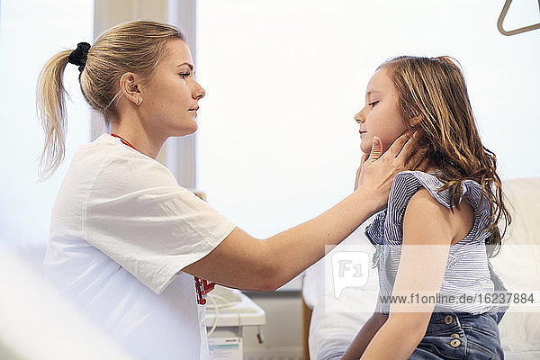 Female doctor examining girl